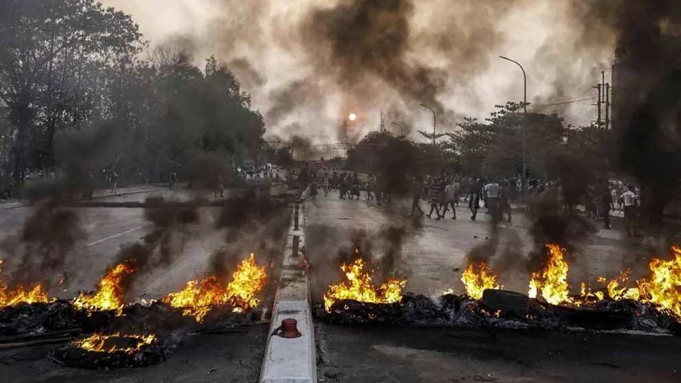 Manifestantes bloquean una carretera prendiendo fuego a neum&aacute;ticos durante una protesta en Rang&uacute;n (Birmania).  EFE