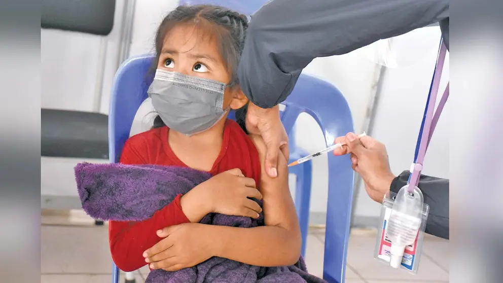 Una niña es inmunizada contra la COVID-19 en un punto de vacunación masiva. DICO SOLÍS