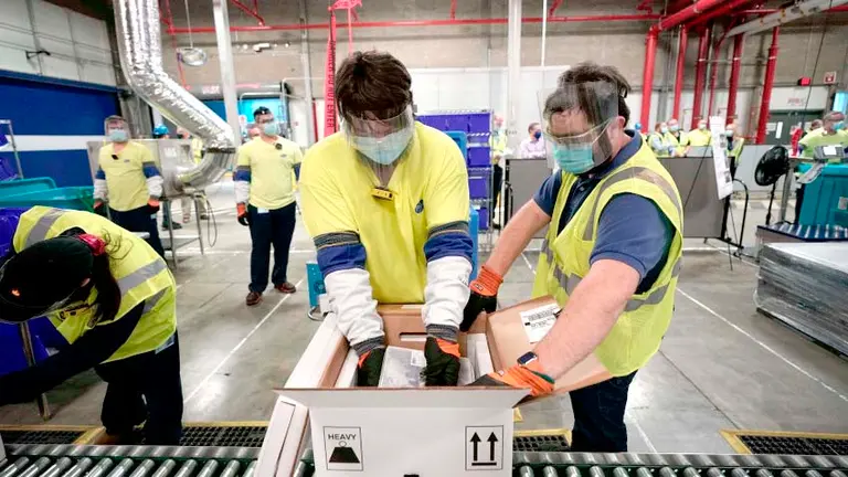 PORTAGE, MICHIGAN - DECEMBER 13: Boxes containing the Pfizer-BioNTech COVID-19 vaccine are prepared to be shipped at the Pfizer Global Supply Kalamazoo manufacturing plant on December 13, 2020 in Portage, Michigan. (Photo by Morry Gash - Pool/Getty Images)