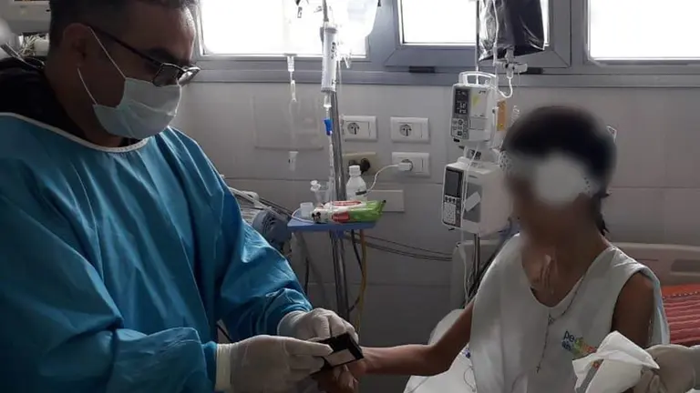 Un funcionario de SEGIP atiende a una ni&ntilde;a en un centro de salud en La Paz. ABI