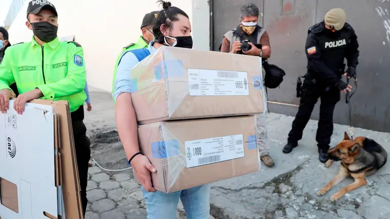 Un funcionario del Consejo Nacional Electoral ecuatoriano ingresa a un centro penitenciario con las papeletas electorales, en Quito (Ecuador). EFE