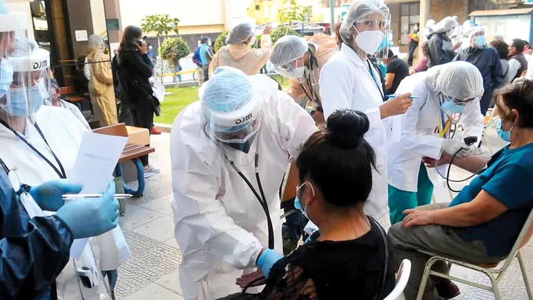 Personas aguardan una dosis contra el coronavirus en la Facultad de Medicina. NOÉ PORTUGAL