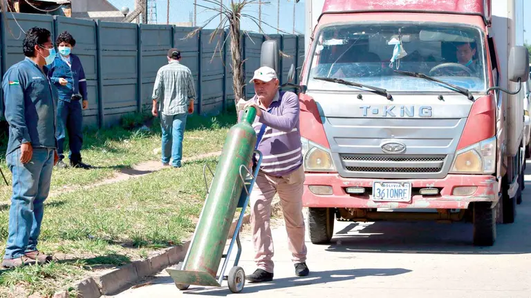 Una persona espera para cargar su tanque de oxígeno. EFE
