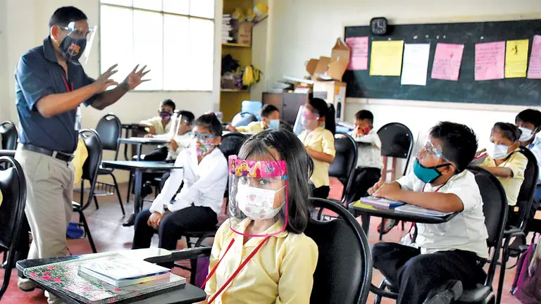 Un grupo de escolares pasa clases con medidas de bioseguridad debido al brote de COVID. DICO SOLÍS
