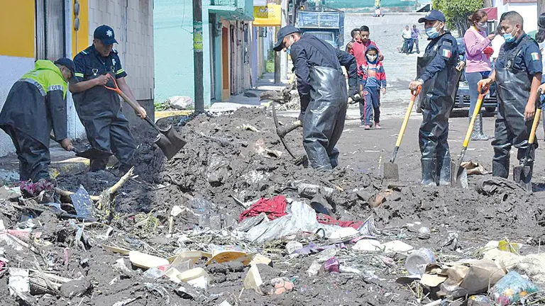 Policiales estatales remueven basura y tierra en Ecatepec, en Ciudad de México.   EFE