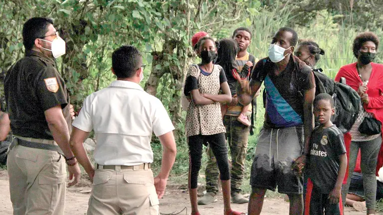 Funcionarios del Instituto Nacional de Migración y elementos de la Guardia Nacional detienen a migrantes haitianos. EFE