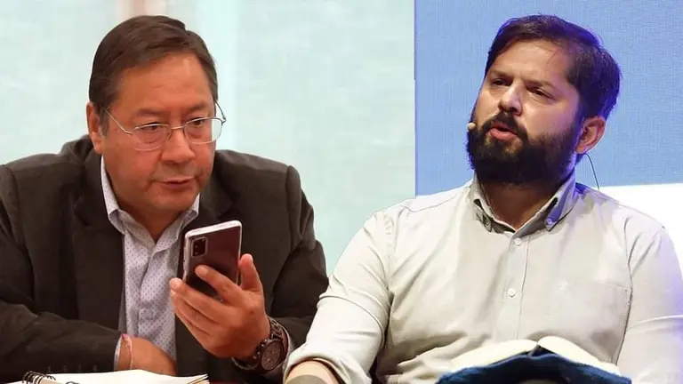El presidente Luis Arce (i), en el momento en que sosten&iacute;a la conversaci&oacute;n por tel&eacute;fono con Gabriel Boric. FOTO COMPUESTA OPINI&Oacute;N