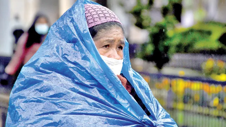 Una vendedora cubierta del frío con un plástico. DICO SOLÍS