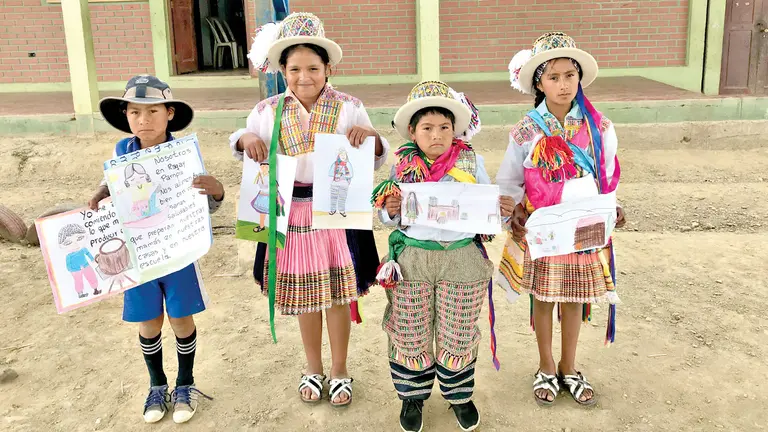 Niños y niñas raqaypampeños exhiben dibujos suyos y de sus compañeros. SANTIAGO ESPINOZA