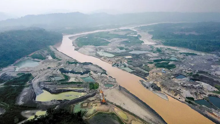 Vista aerea del r&iacute;o Kaka, a orillas del pueblo de Mayaya, donde se observa un afluente de color rojizo producto del lavado de oro por una empresa china./ MANUEL SEOANE