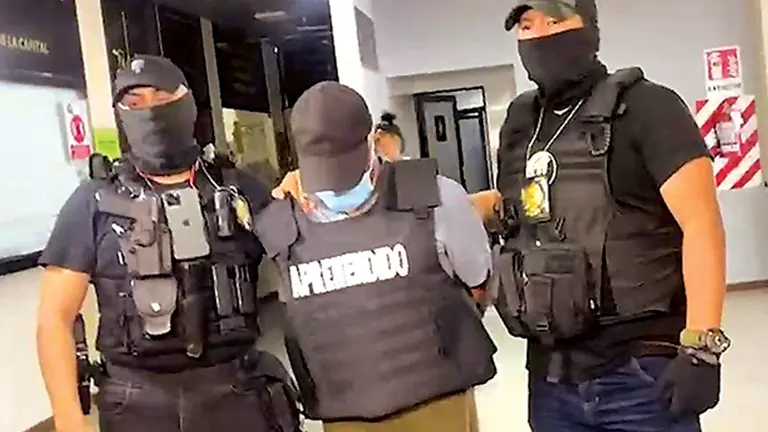 El policía Pedro T.S. (c) es trasladado después de su sentencia de 30 años  de privación de libertad por un feminicidio y homicidio./ UNITEL
