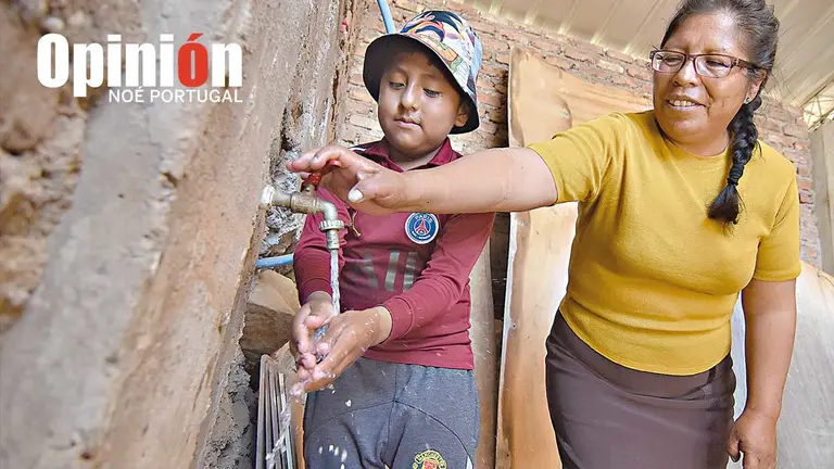 Una familia agarra agua en Sivingani, al sur./ NO&Eacute; PORTUGAL