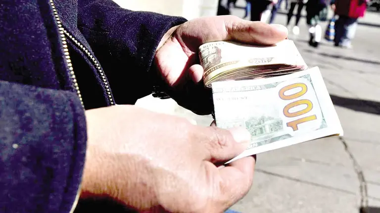Imagen referencial de una transacci&oacute;n con d&oacute;lares y bolivianos en el mercado paralelo./ P&Aacute;GINA SIETE